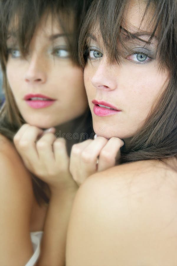 Beautiful young woman posing mirror