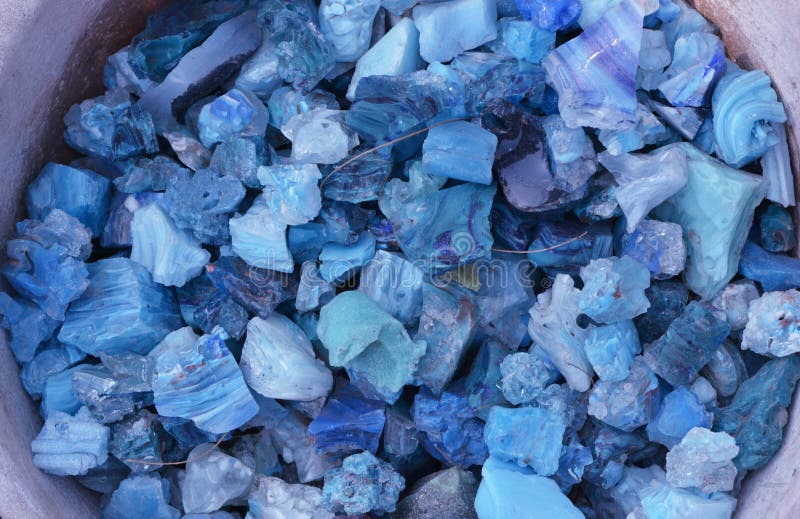 Beautiful shiny blue colorful stones in clay vessel. Beautiful shiny colourful blue stones in clay vessel on the ground royalty free stock photos Beautiful shiny blue colorful stones in clay vessel. Beautiful shiny colourful blue stones in clay vessel on the ground royalty free stock photos