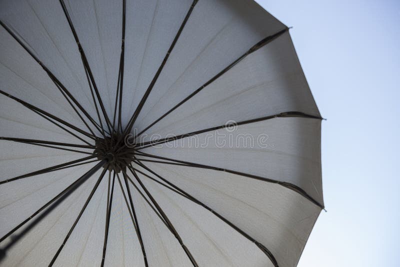 Beautiful Shot of the Inner Part of a Black Umbrella with the Blue Sky