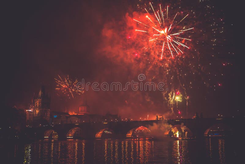Beautiful shot of a red-colored firework in the night sky above a bridge on a river royalty free stock photography Beautiful shot of a red-colored firework in the night sky above a bridge on a river royalty free stock photography