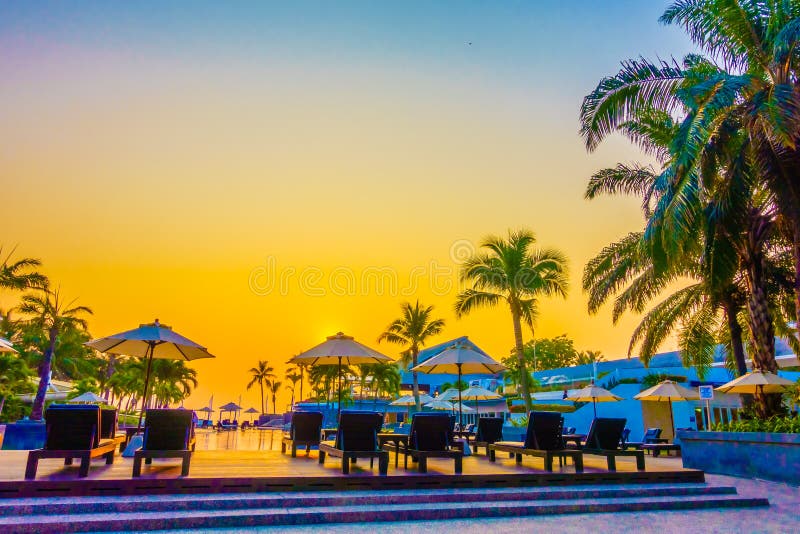 Beautiful Silhouette palm tree with umbrella and chair