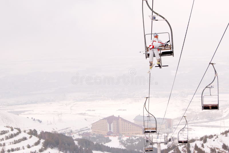 Beautiful skier lift up on chairlift