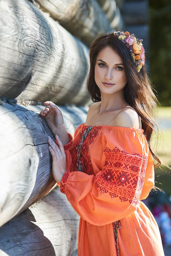 Beautiful Slavic Woman in an Orange Ethnic Dress and a Wreath of ...