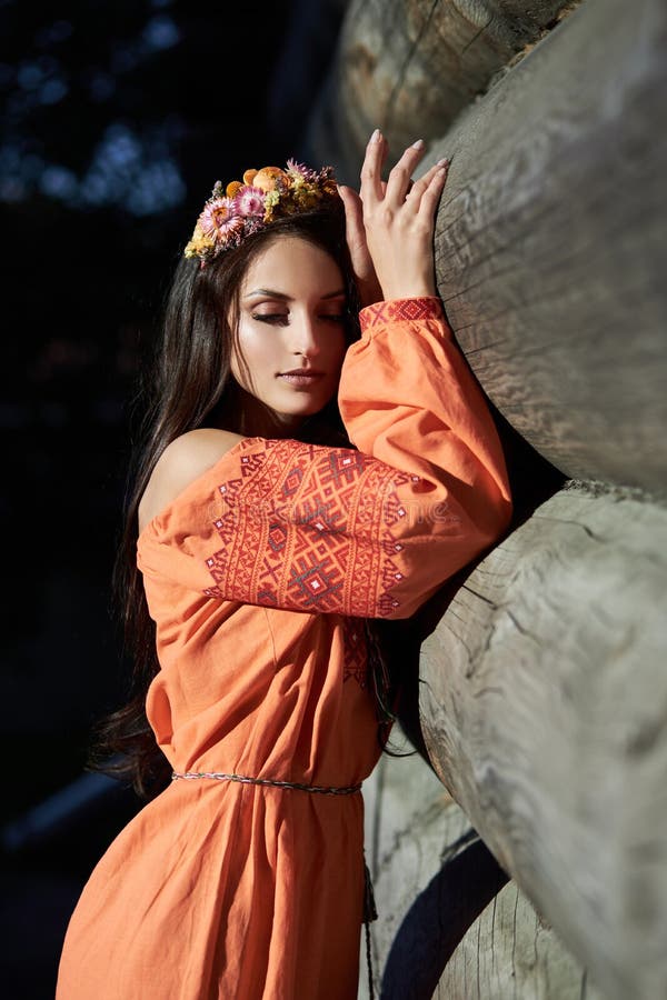 https://thumbs.dreamstime.com/b/beautiful-slavic-woman-orange-ethnic-dress-wreath-flowers-her-head-natural-makeup-portrait-russian-girl-196207655.jpg