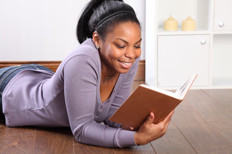 Beautiful smile from young girl reading a book