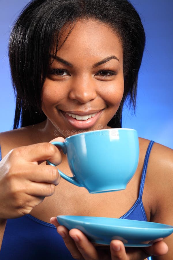 Beautiful smiling black drinking tea
