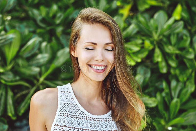 Beautiful smiling girl with eyes closed