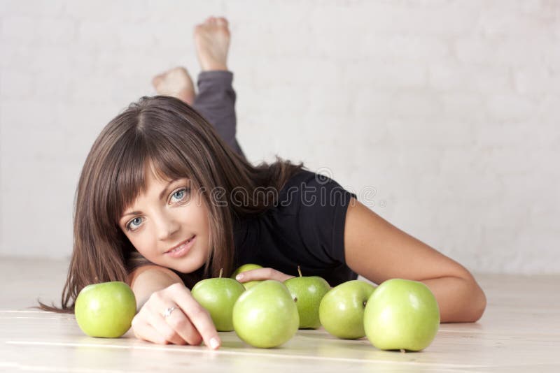 Beautiful smiling girl with green apples stock photography