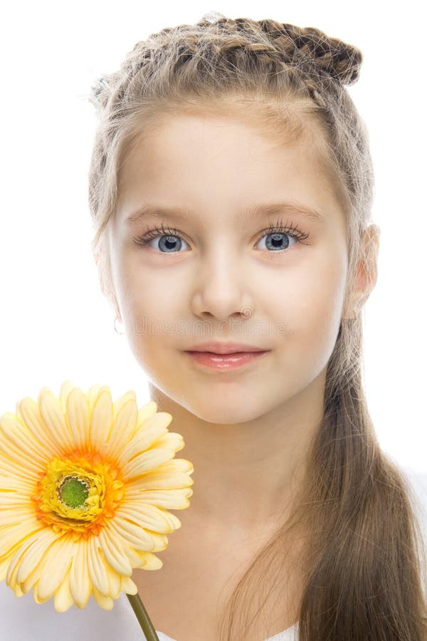 Beautiful smiling girl with yellow flower