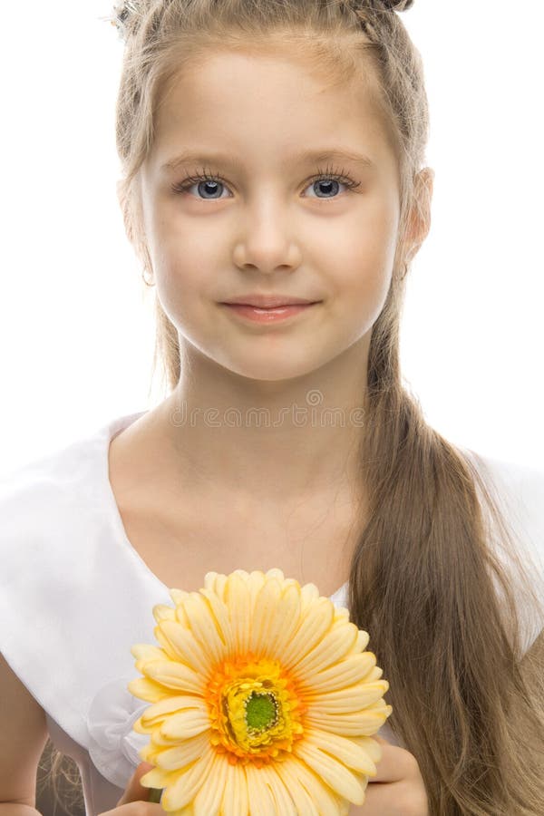 Beautiful smiling girl with yellow flower