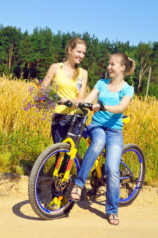 Beautiful smiling girls rest from ride bicycle