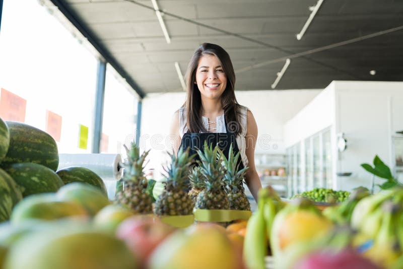 Female Owner Standing With Fresh Healthy Produce In Store