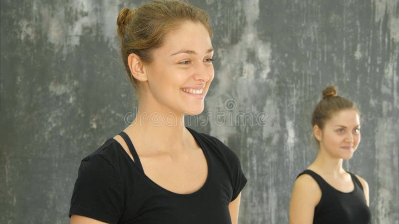 Beautiful smiling happy young woman working out indoors, standing and talking to a group stock photos Beautiful smiling happy young woman working out indoors, standing and talking to a group stock photos