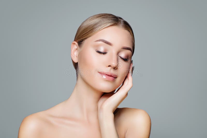 Beautiful smiling woman with clear skin relaxing. Facial treatment, haircare and cosmetology concept stock photos Beautiful smiling woman with clear skin relaxing. Facial treatment, haircare and cosmetology concept stock photos