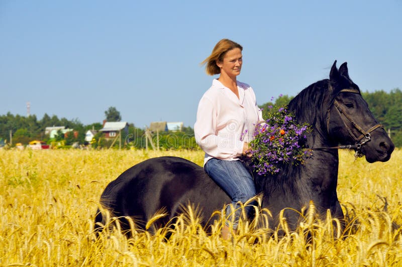 Beautiful smiling woman rides horse