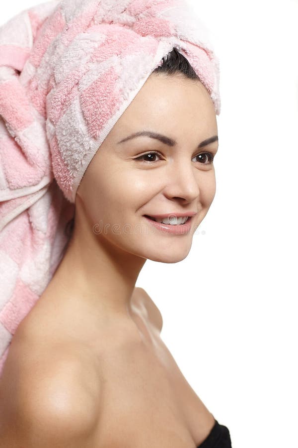 Beautiful smiling woman in towel on the head