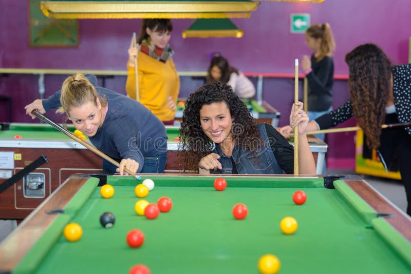 Beautiful smiling women playing billiards at bar royalty free stock image Beautiful smiling women playing billiards at bar royalty free stock image