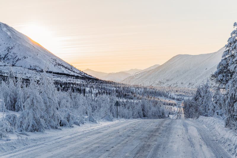 beautiful snow covered winter road with road sign and trees in mountains, stock images beautiful snow covered winter road with road sign and trees in mountains, stock images
