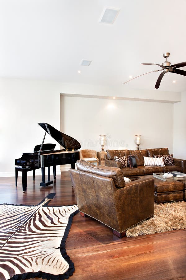 Beautiful sofa table and piano with zebra printed carpet in draw