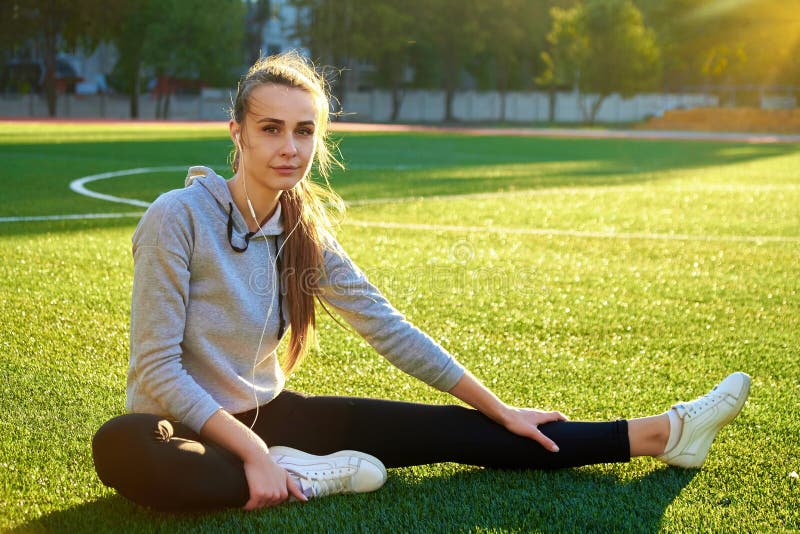 Beautiful sport woman doing stretching fitness exercise in city park at green grass. Yoga postures royalty free stock image Beautiful sport woman doing stretching fitness exercise in city park at green grass. Yoga postures royalty free stock image