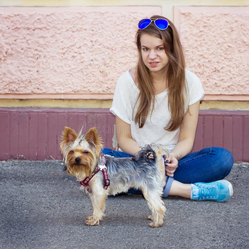 Beautiful sport woman sitting on the floor and Yorkshire terrier stock photos Beautiful sport woman sitting on the floor and Yorkshire terrier stock photos