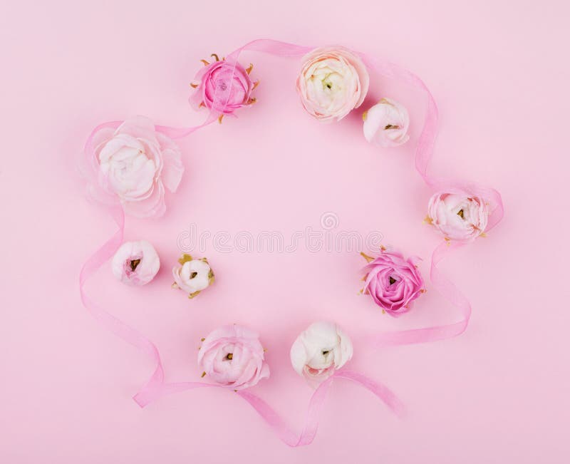 Beautiful spring flower on pink desk from above for wedding mockup or greeting card on womans day. Floral frame in flat lay stock photography Beautiful spring flower on pink desk from above for wedding mockup or greeting card on womans day. Floral frame in flat lay stock photography
