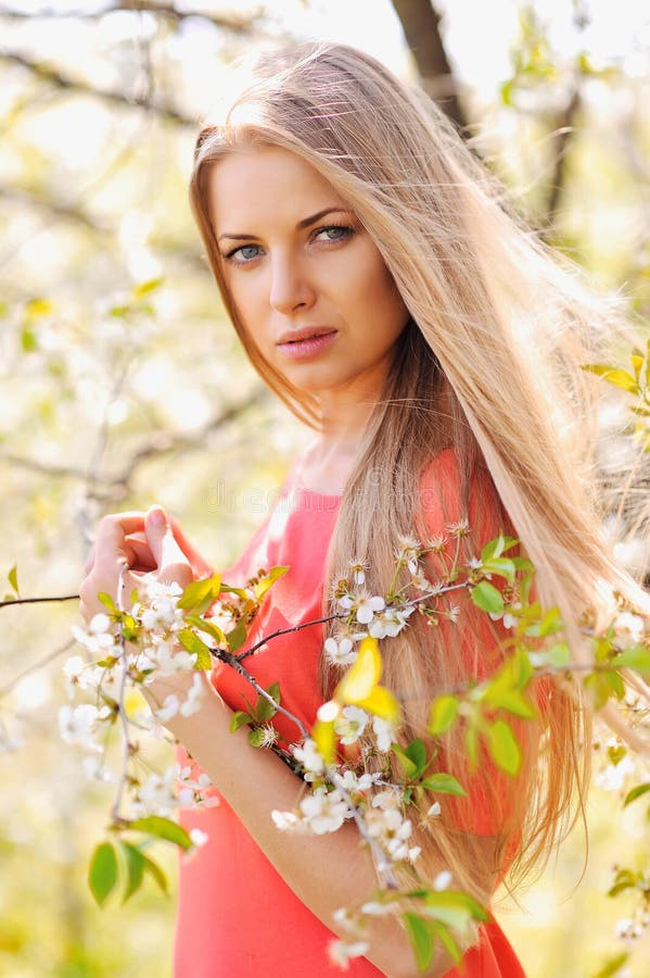 Beautiful spring girl in blooming garden