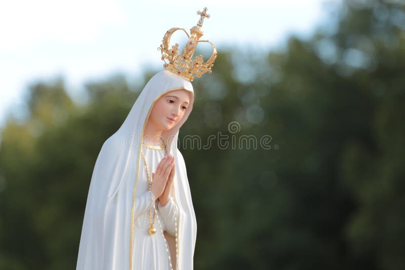 Beautiful statue of the Virgin Mary praying with her hands joined ,with a crown. Our Lady of Fatima.  Paray-le-Monial, France. Beautiful statue of the Virgin Mary praying with her hands joined ,with a crown. Our Lady of Fatima.  Paray-le-Monial, France.