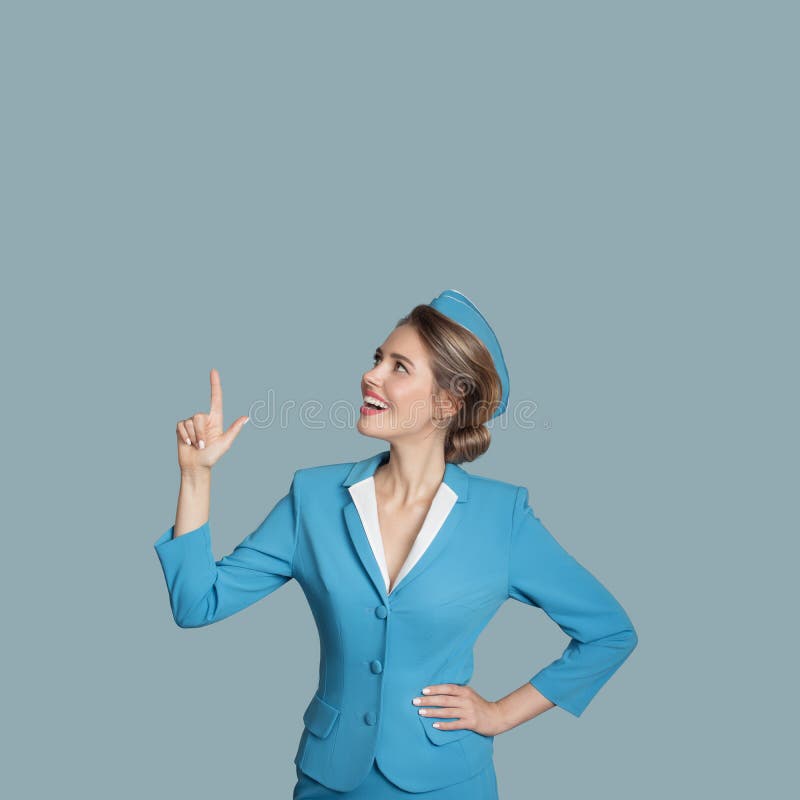Beautiful stewardess points a finger on copyspace. stock photos Beautiful stewardess points a finger on copyspace. stock photos