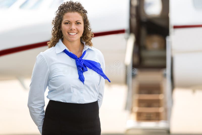 Beautiful Stewardess With Private Jet In stock photo