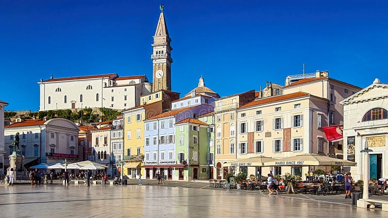 Beautiful street landscape on the central square with a monument and an ancient watch tower in Piran, the tourist center of