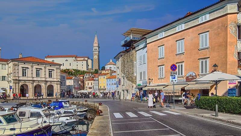 Beautiful street landscape on the central square with a monument and an ancient watch tower in Piran, the tourist center of