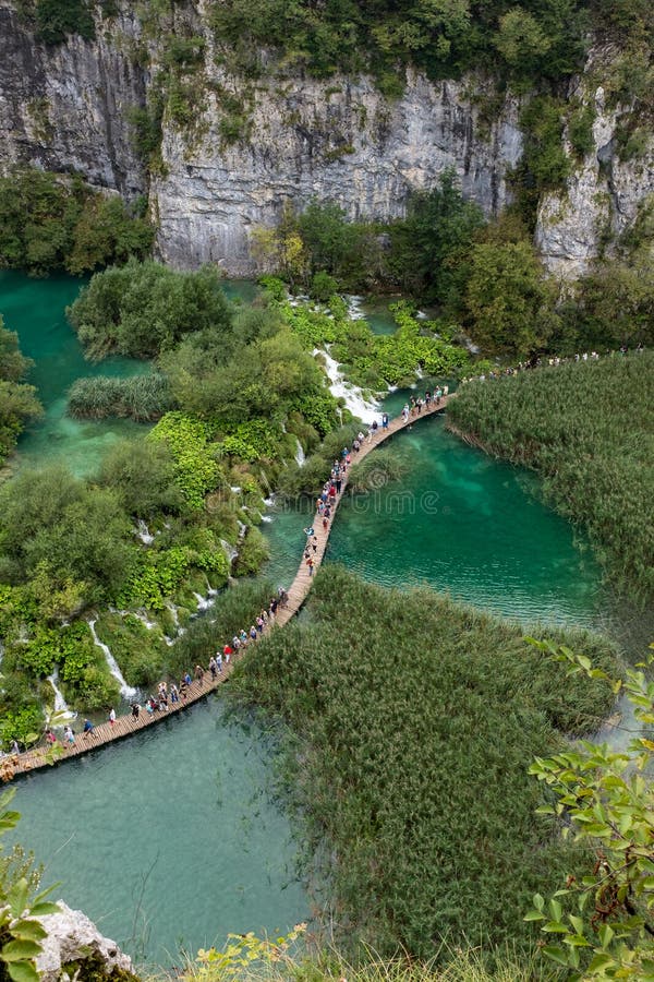 The beautiful and stunning Plitvice Lake National Park, Croatia, aerial shot of a broad walk with people stock photo The beautiful and stunning Plitvice Lake National Park, Croatia, aerial shot of a broad walk with people stock photo
