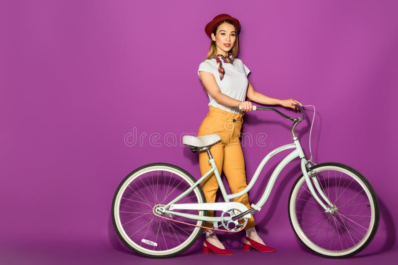 beautiful stylish asian girl standing with bike and smiling at camera stock images beautiful stylish asian girl standing with bike and smiling at camera stock images