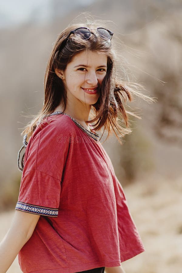 Beautiful stylish woman hipster smiling and having fun in sunny mountains, cheerful moment of happiness