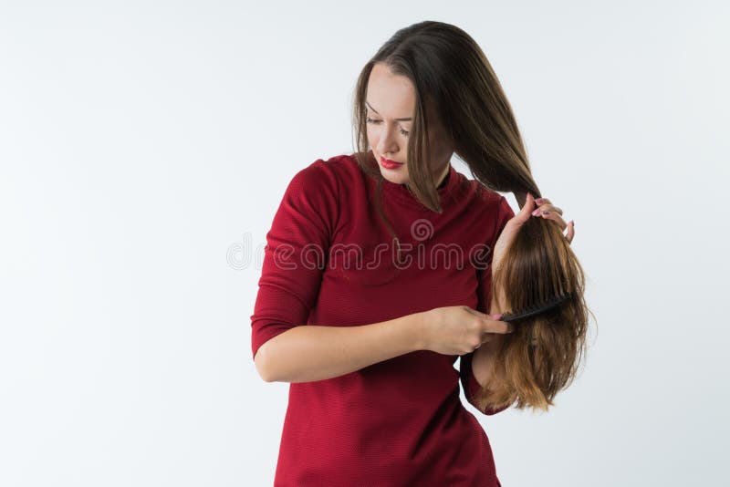 Beautiful stylish young girl combs her hair with a comb. stock images Beautiful stylish young girl combs her hair with a comb. stock images