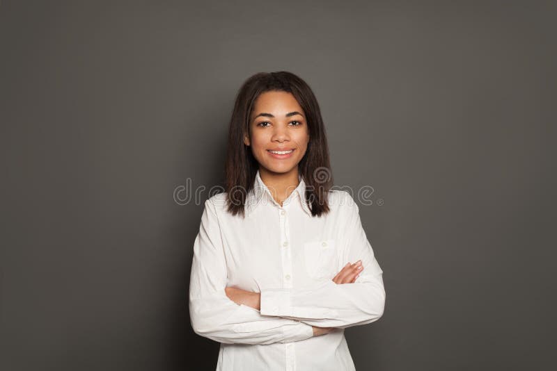 Beautiful successful happy smart African American woman with crossed arms on gray background royalty free stock photos Beautiful successful happy smart African American woman with crossed arms on gray background royalty free stock photos