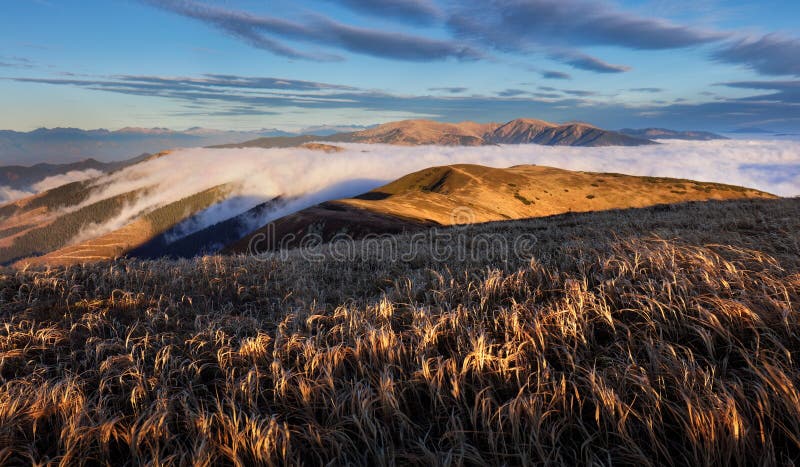 Beautiful sunrise. Clouds over the mountains. Autumn Landscape