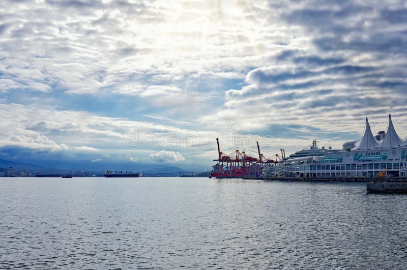 Beautiful sunrise over the bay at downtown Vancouver with Canada Place. The first sun`s rays shine through cirrus clouds royalty free stock photo Beautiful sunrise over the bay at downtown Vancouver with Canada Place. The first sun`s rays shine through cirrus clouds royalty free stock photo