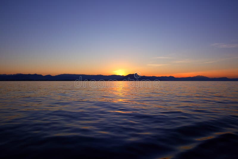 Beautiful sunrise over blue sea ocean red sky