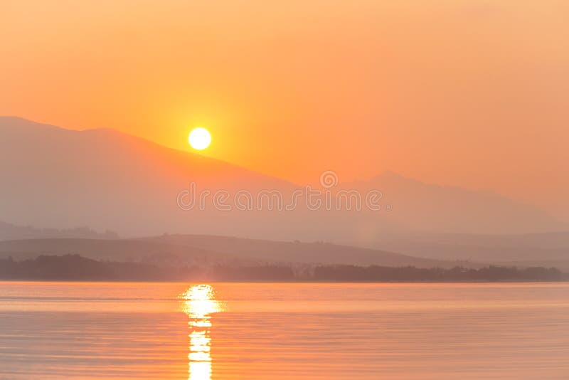 A Beautiful Sunrise Over The Lake With Mountains In Distance Morning