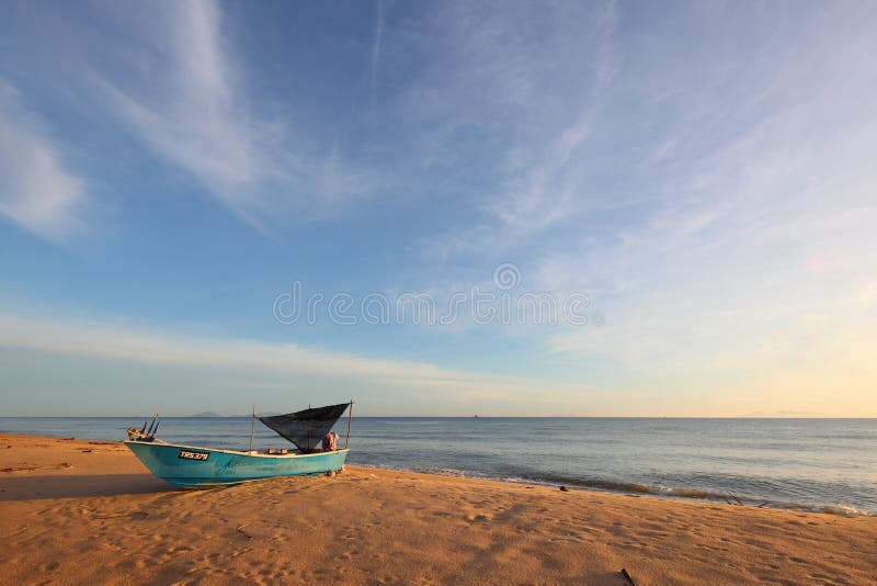 Beautiful sunset beach with fisherman boat