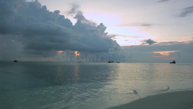 Beautiful sunset on beach. Gorgeous backgrounds. Blue water and white sand on light blue sky and white clouds background.