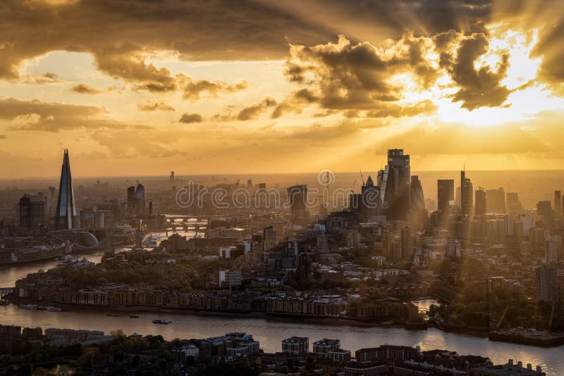 A beautiful sunset behind the urban skyline panorama of London, Englandrom the City skyscrapers to London Bridge