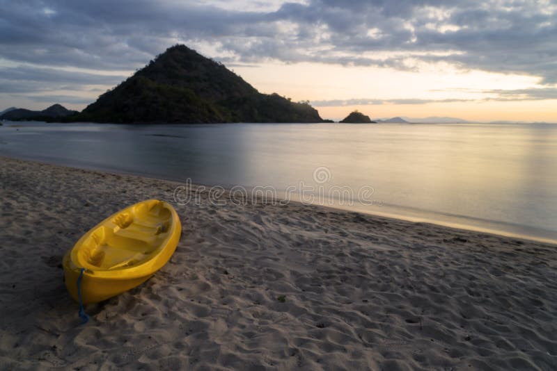 Beautiful sunset with empty yellow canoe stock images