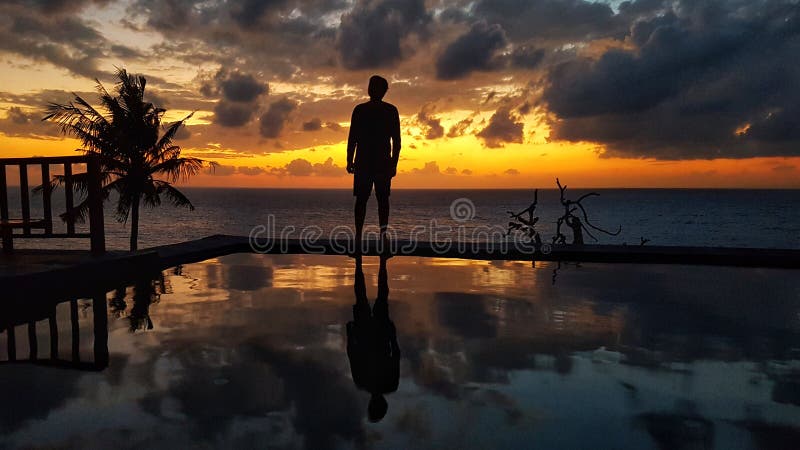 Beautiful Sunset at the ocean beach with man