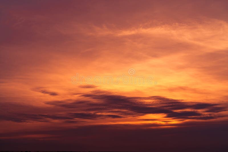 Beautiful sunset sky. Golden sky at sunset. Art picture of sky and dark clouds at dusk. Peaceful and tranquil concept. Twilight.