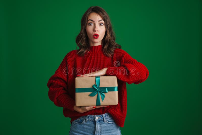 Beautiful surprised nice girl posing with Christmas gift box