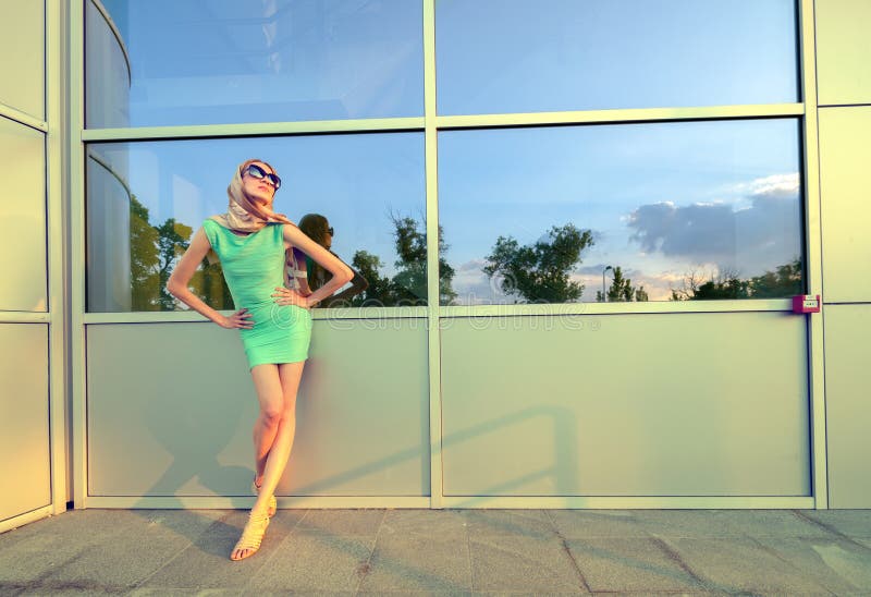 Beautiful tall fashion model posing in front of modern building stock photos Beautiful tall fashion model posing in front of modern building stock photos