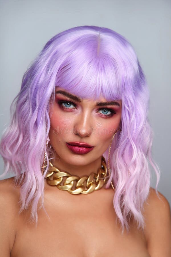 Beautiful tanned woman with lilac hair and bright fancy makeup